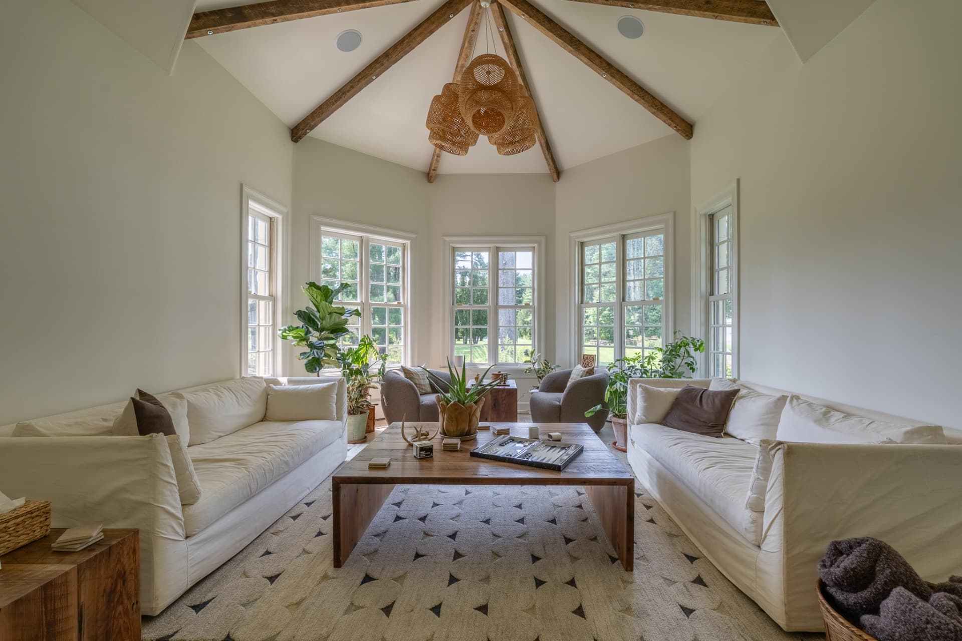 The great room at the Lundy House, beamed ceiling and linen sofas